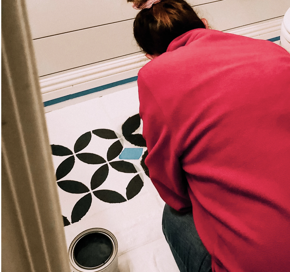 overhead shot of woman painting tile floor